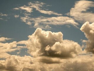 White clouds over sunset summer sky background. Fluffy cumulus clouds shape