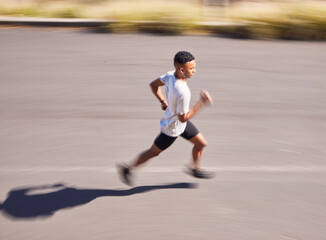 Fototapeta premium Health, running and motion blur with a sports man on a road for his cardio or endurance workout from above. Exercise, fitness and a runner training for a marathon in the mountains during summer