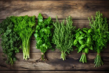 Various fresh herbs on wooden background.