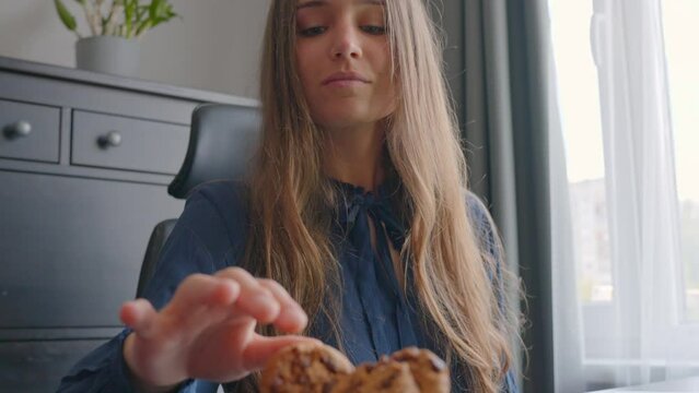 Young beautiful woman avoid eating carbs - delicious chocolate cookies