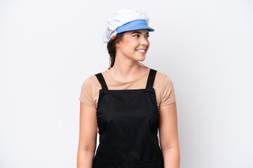 Fishmonger brazilian woman wearing an apron isolated on white background looking side