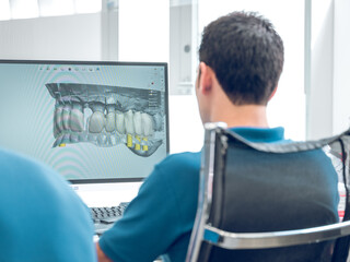 Dentist working with digital teeth image in dental clinic