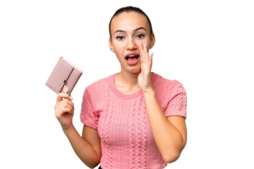 Young Arab woman holding a wallet over isolated background shouting with mouth wide open