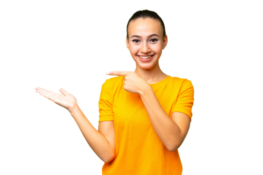 Young Arab woman over isolated background holding copyspace imaginary on the palm to insert an ad