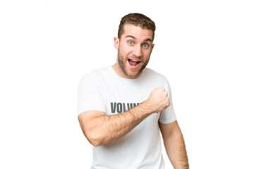 Young volunteer man over isolated chroma key background celebrating a victory