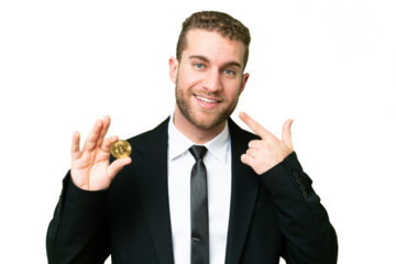 Young business blonde man holding a Bitcoin over isolated chroma key background giving a thumbs up gesture