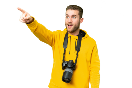 Young photographer man over isolated chroma key background pointing away