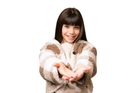 Little girl over isolated green chroma key background holding copyspace imaginary on the palm to insert an ad