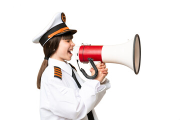 Little girl as a Airplane pilot over isolated chroma key background shouting through a megaphone