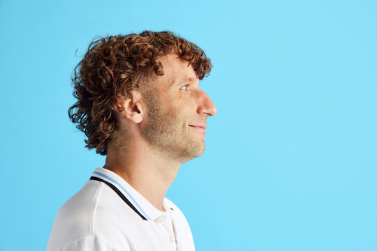 Side View Image If Curly Mature Man With Bristle Face Looking Straight Against Blue Studio Background. Concept Of Human Emotions, Facial Expression, , Fashion, Business, Ad