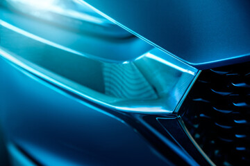 Closeup detail of blue luxury car. Electric vehicle with modern technology. Expensive car. Shiny...