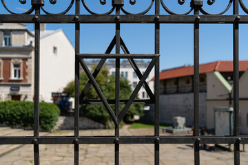 Star of David on metal fence outside synagogue on Szeroka street in Krakow, Poland. Symbol of...