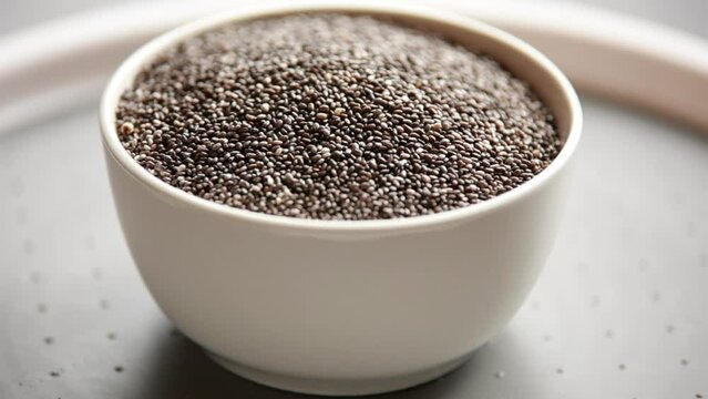 close up raw chia seed in a white bowl on the table