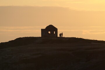 Little house on the hill at sunset