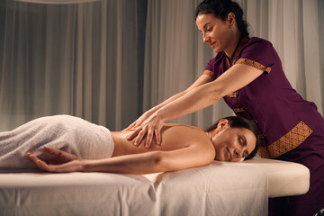 Obraz na płótnie Canvas Massotherapist giving lower back massage to patient