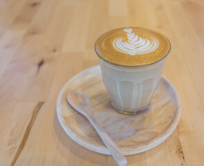 coffee with milk in a cup on wooden table