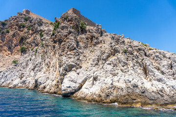 Fototapeta na wymiar Sea waves and fantastic rocky coast diving place Alanya Turkey 