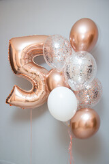 balloons for 5 years, helium balloons in rose gold color on a white background, 5 years