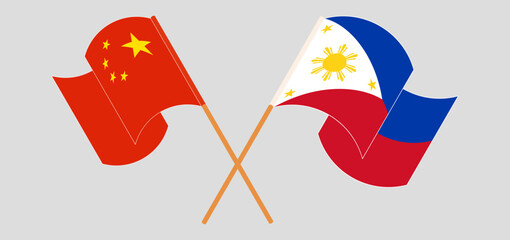 Crossed and waving flags of China and the Philippines