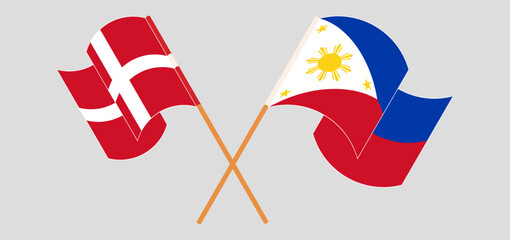 Crossed and waving flags of Denmark and the Philippines