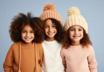  Three little girls wearing comfy warm clothes and wool hats in pastel colors, posing and smiling. Fall winter fashion for kids. Generative AI © Miss V