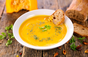 pumpkin soup in bowl with rustic bread