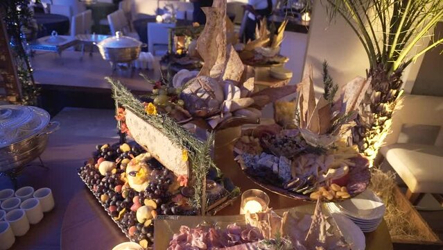 cold cuts table with cheeses, breads, fruits, festive table, event food table