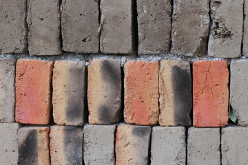pile of neatly arranged raw bricks, not yet burnt, made of earth