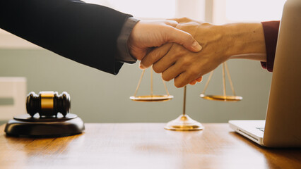 Businessman shaking hands to seal a deal with his partner lawyers or attorneys discussing a contract agreement