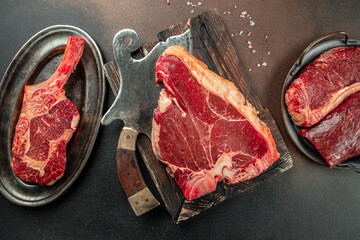 Variety of Raw Black Angus Prime meat steaks T-bone, tomahawk, New York steak. Set raw marbled beef...