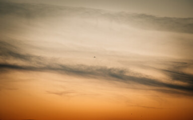 Fototapeta na wymiar airplane at sunset in the clouds
