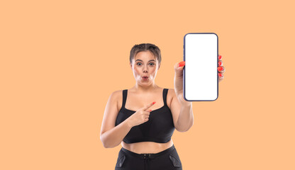 Size plus model advertises black friday sale in online shop with big sizes. Dietetic fitness program template. Girl demonstrates the screen of a smartphone for the presentation of a mobile application