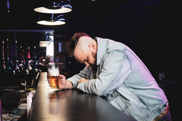drunk brutal man with an alcoholic cocktail in a glass. The concept of bad habits and alcohol...