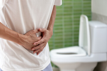 Constipation and diarrhea in bathroom. Hurt man touch belly  stomach ache painful. colon...