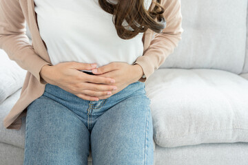stomach ache. Asian women have abdominal pain, indigestion, gastritis, menstrual cramps,...