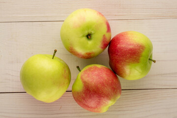 Several green apples on a wooden table, macro, top view.