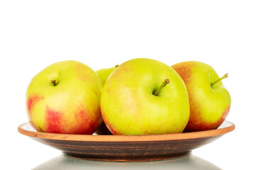 Several organic juicy apples on a clay plate, macro, isolated on white background.