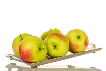 Several organic juicy apples on a metal tray, macro, isolated on white background.