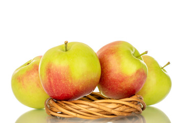 Four organic juicy apples with vine wreath, macro, isolated on white background.