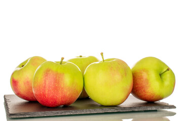 Several sweet juicy apples on slate stone, macro, isolated on white background.