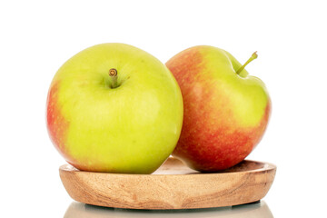 Two sweet juicy apples on a wooden plate, macro, isolated on white background.