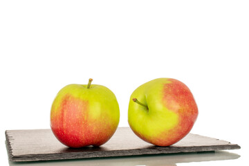 Two sweet juicy apples on slate stone, macro, isolated on white background.