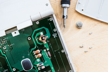 battery replacement in circuit board of disassembled accounting calculator close up