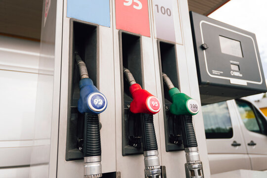 Refueling gun various colors close-up. Gas and oil station with diesel and gasoline fuel.