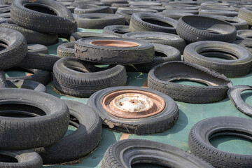 Old car tires on silaged fodder on a dairy farm