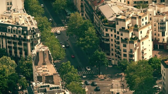 View from above of a quiet green steet with residential buildings and classic attics in Paris, France
