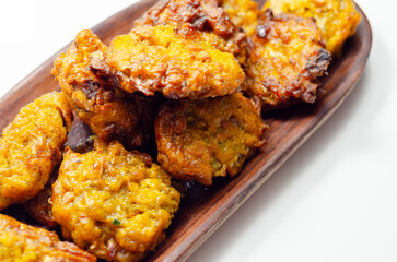 Delicious onion bhaji fritters served on wooden plate as a starter