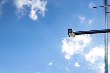 cctv camera is installed on the Metal stick that hung on to electric pole beside the street in...