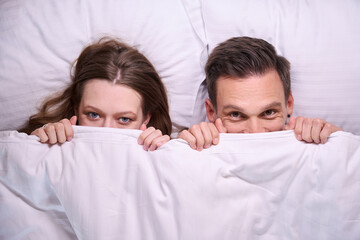 Close up of couple covered with white blanket
