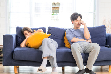 Asian newlywed business people trying to manage work and housework tasks, Young attractive couple getting tired after moving to new house sleeping on sofa at home, housewife multitasking concept